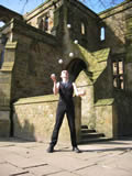 Ben Jennings juggling six balls in a half shower